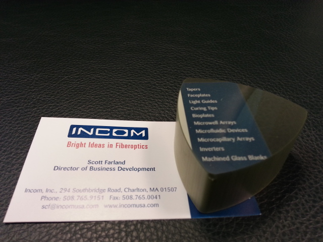 Incom's fused fiber optic image transfers the image from the business card to the top of the optic